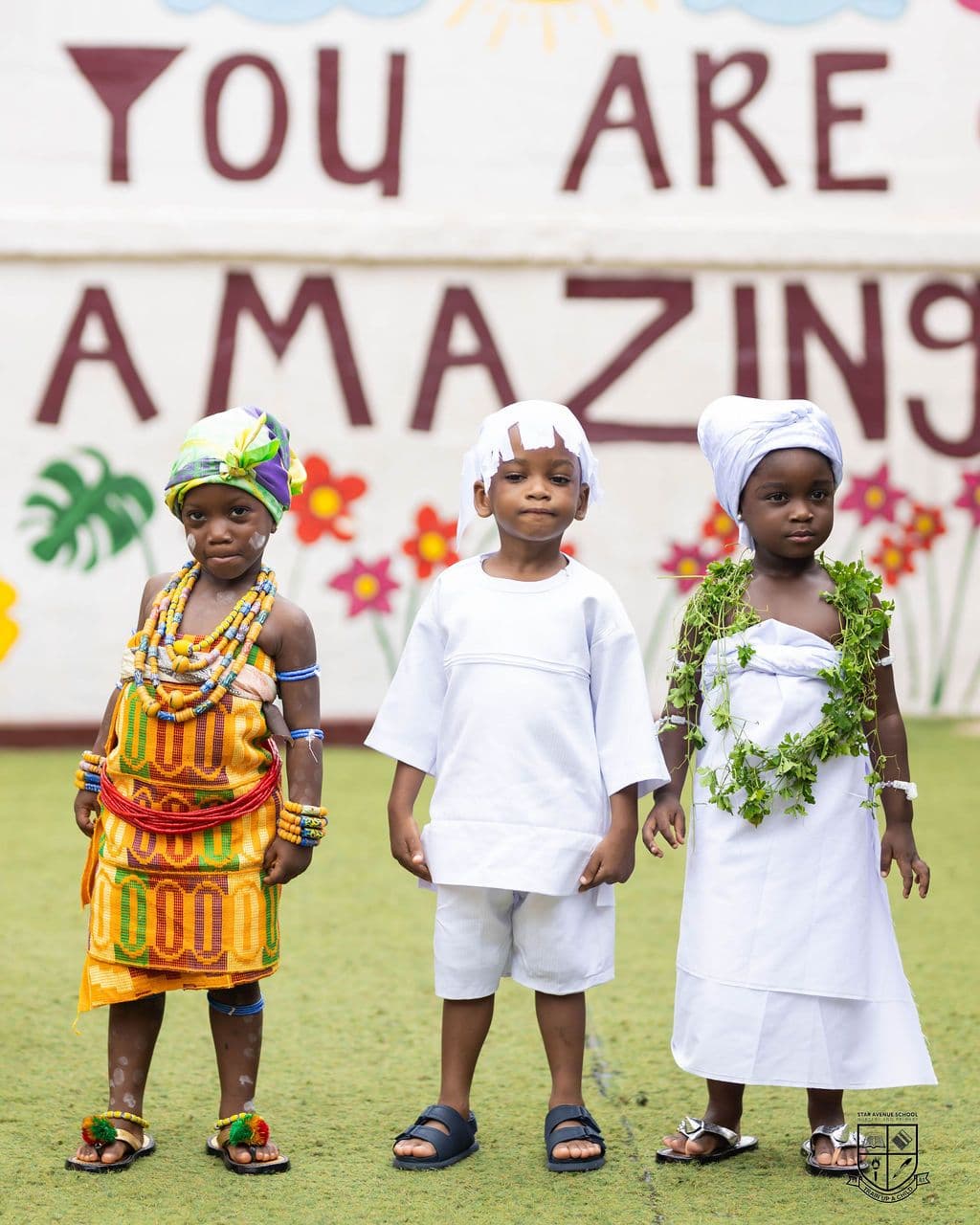 The youngest classes in white and kente