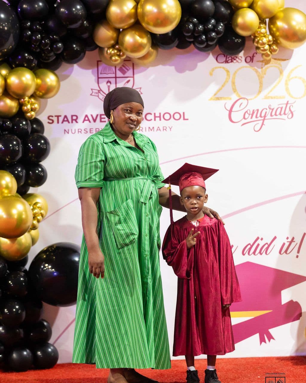 A graduate with her class teacher on the red carpet