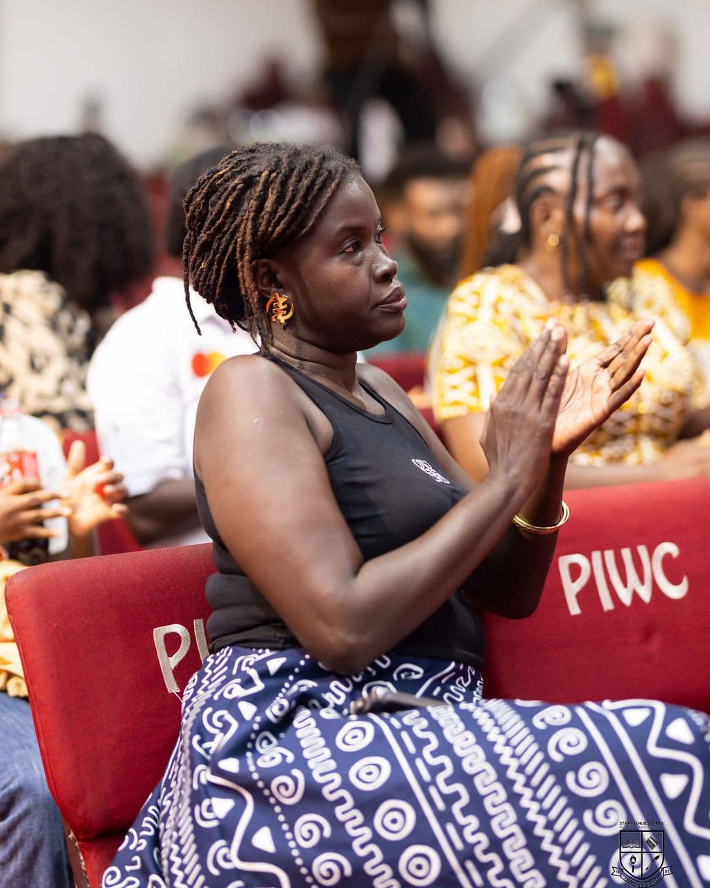 A parent applauding from the audience