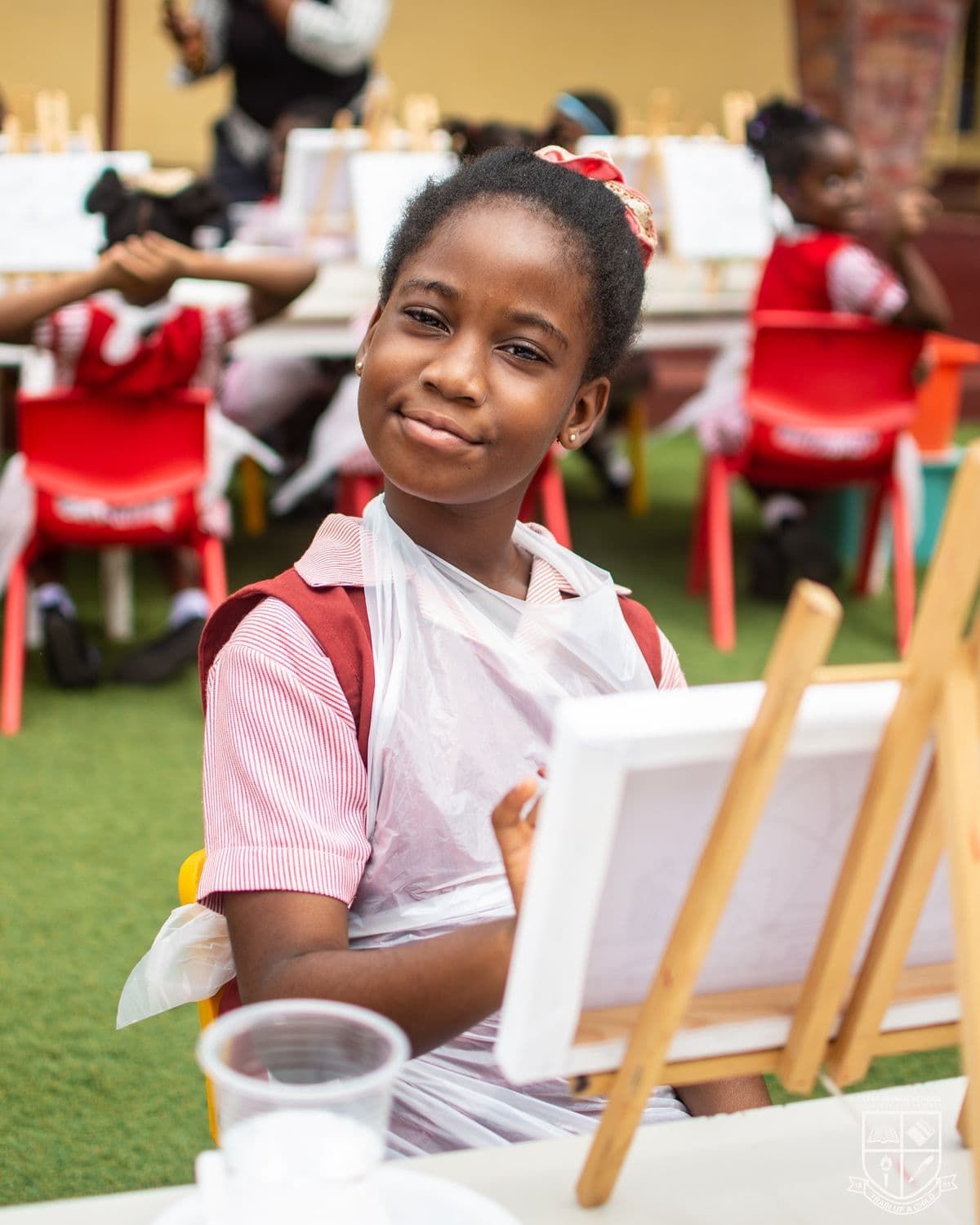 A pupil with the picture she has painted