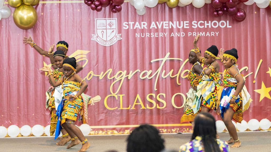 The cultural troupe dancing in kente on the speech day stage