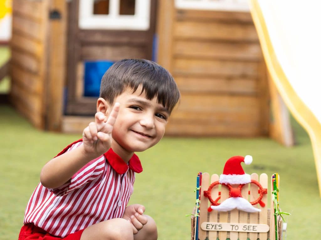 The wooden playhouse and yellow slide in the school playground