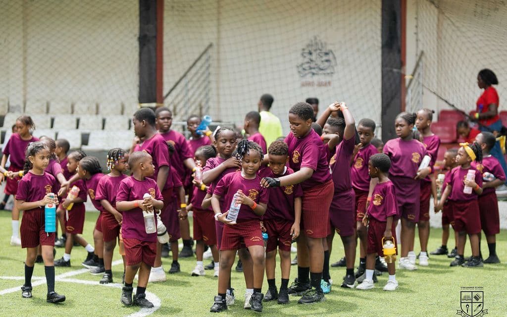 Pupils in house kit spread across the pitch on sports day
